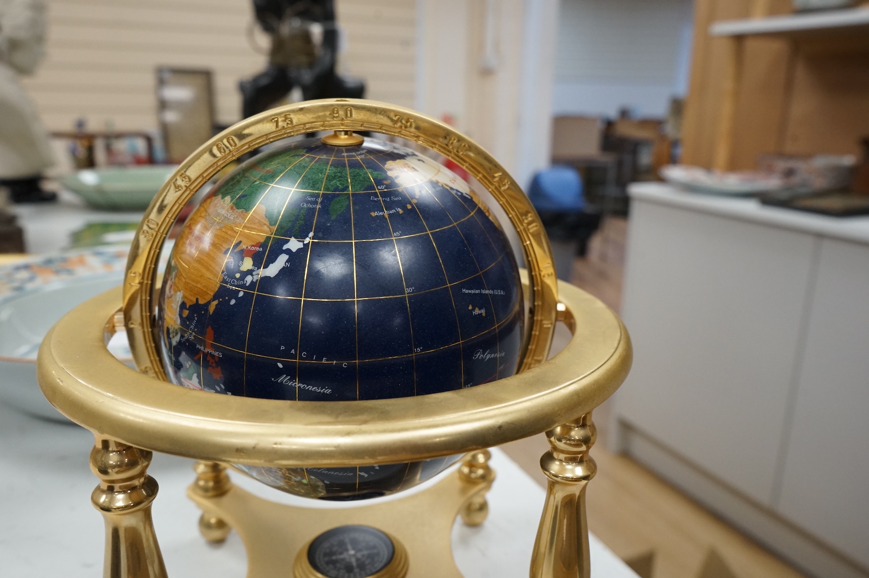 A table-top globe, on brass gimbal stand, 23cm in diameter